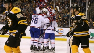 The Canadiens celebrate with David Desharnais after he scored 1:25 into the game. The Bruins had to play catch up all night Saturday(AP Photo/Mary Schwalm)